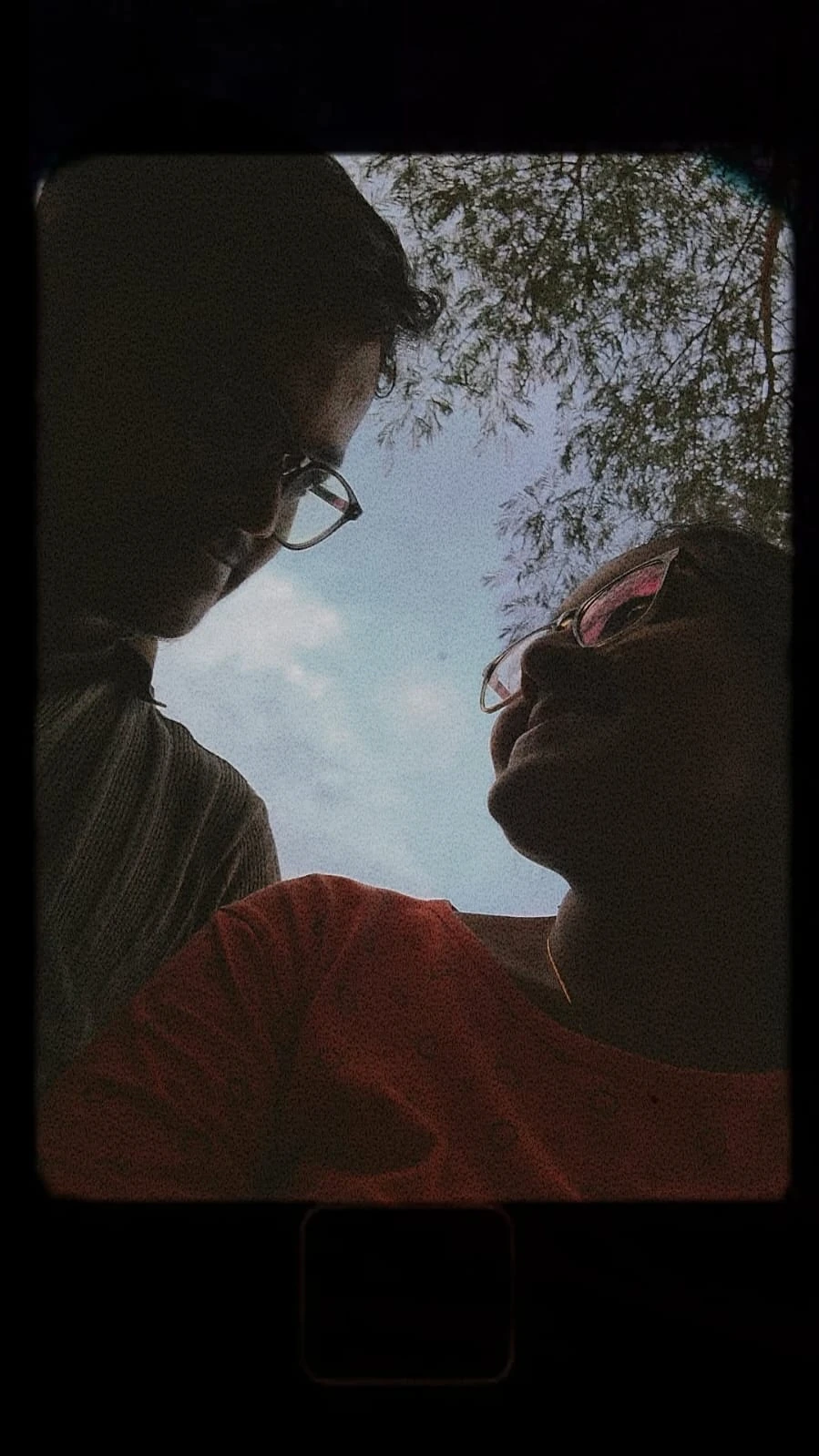 Our silhouettes looking at each other beneath the sky